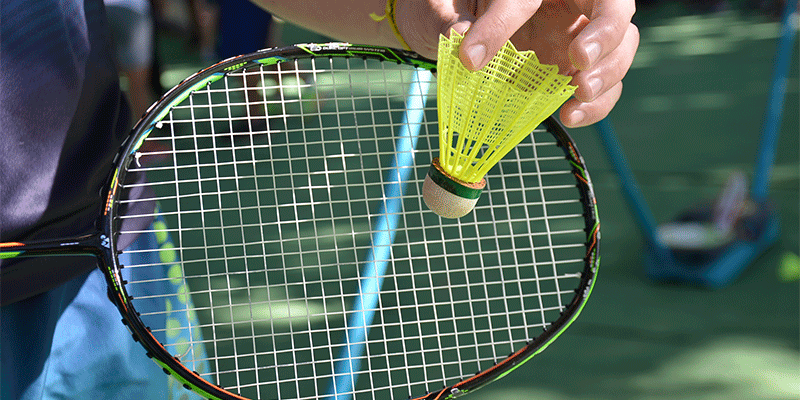 Detalhes de uma raquete e uma peteca utilizadas para a prática de badminton