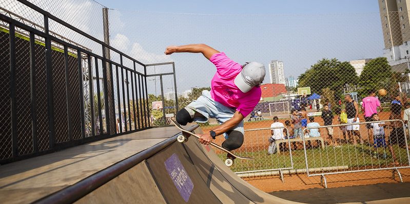 Imagem de uma pessoa fazendo uma manobra de skate em uma pista.