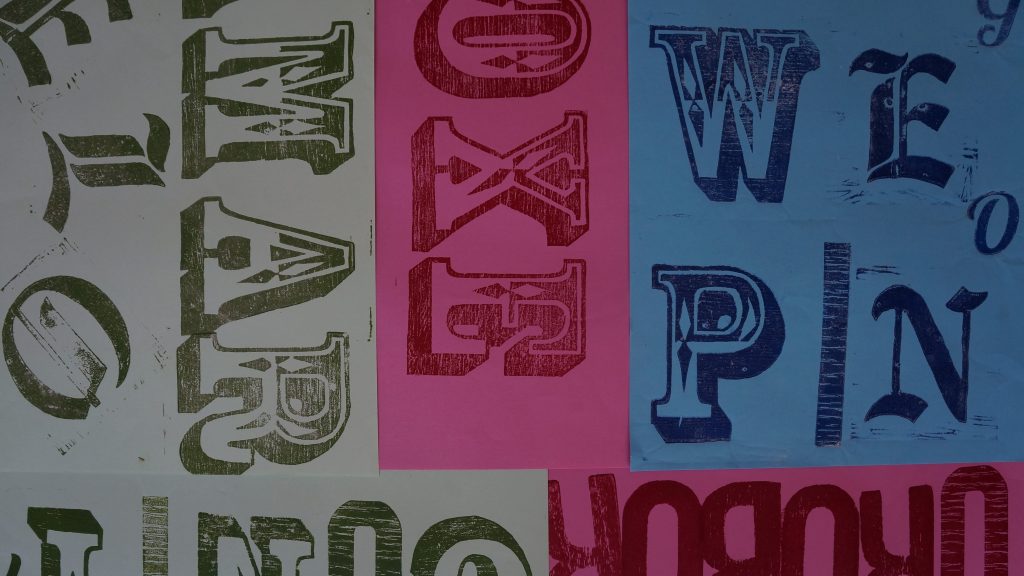 Várias letras tipográficas em papeis diferentes e coloridos
